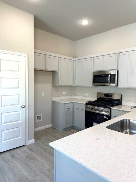 143 Tolo Drive Elgin, TX 78621 - Photo 4 of 30 a kitchen with a refrigerator stove and white cabinets