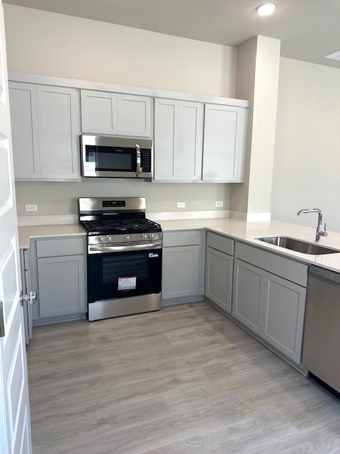 143 Tolo Drive Elgin, TX 78621 - Photo 6 of 30 a kitchen with stainless steel appliances granite countertop a stove sink and cabinets