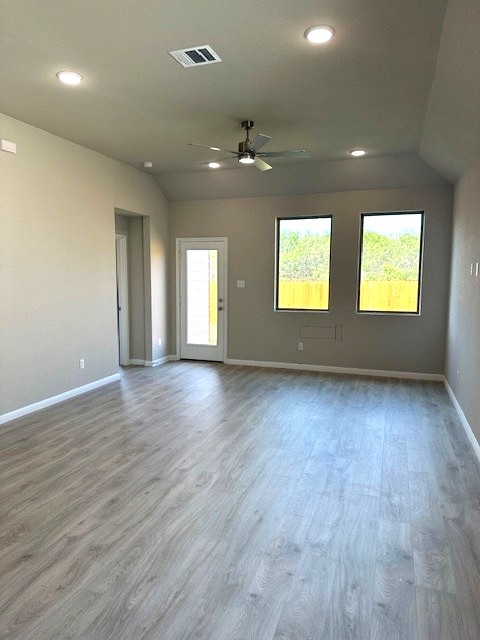 143 Tolo Drive Elgin, TX 78621 - Photo 8 of 30 an empty room with wooden floor and windows