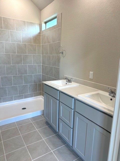 143 Tolo Drive Elgin, TX 78621 - Photo 9 of 30 a bathroom with a tub sink and mirror