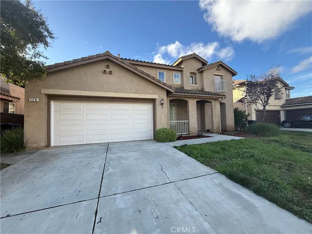 a view of white house with a yard and large tree