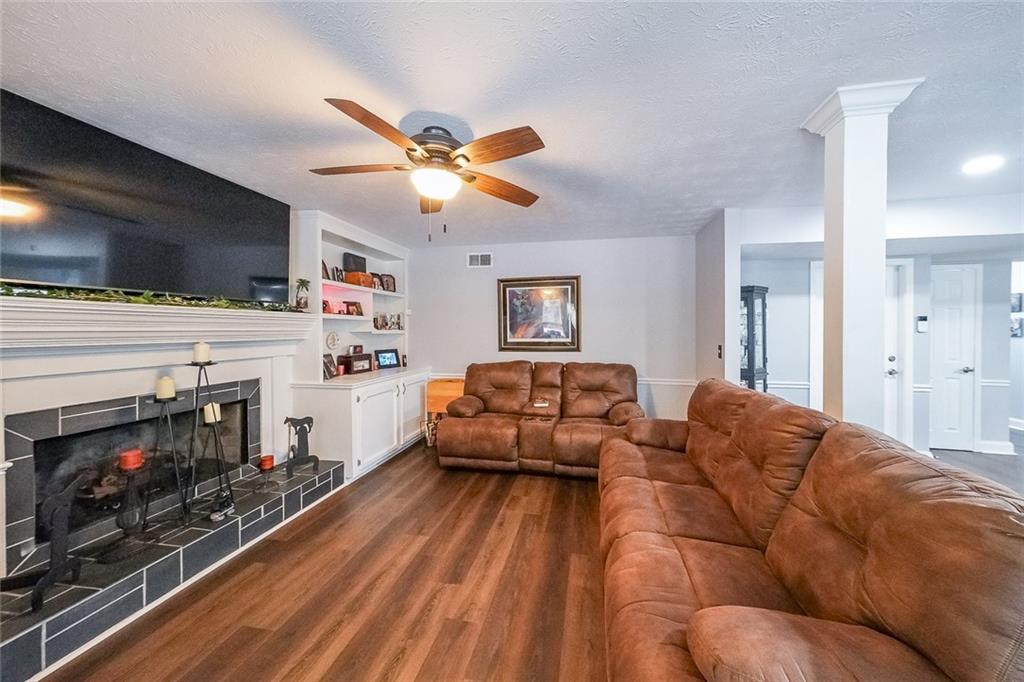4255 Prestley Mill Road Douglasville, GA 30135 - Photo 20 of 43 a living room with furniture a fireplace and a flat screen tv