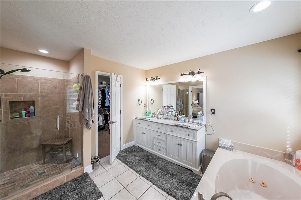 4255 Prestley Mill Road Douglasville, GA 30135 - Photo 32 of 43 a bathroom with a tub sink toilet and shower