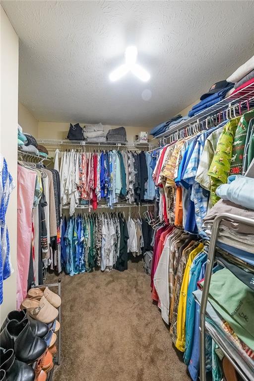 4255 Prestley Mill Road Douglasville, GA 30135 - Photo 34 of 43 a view of walk in closet with clothes and shoes