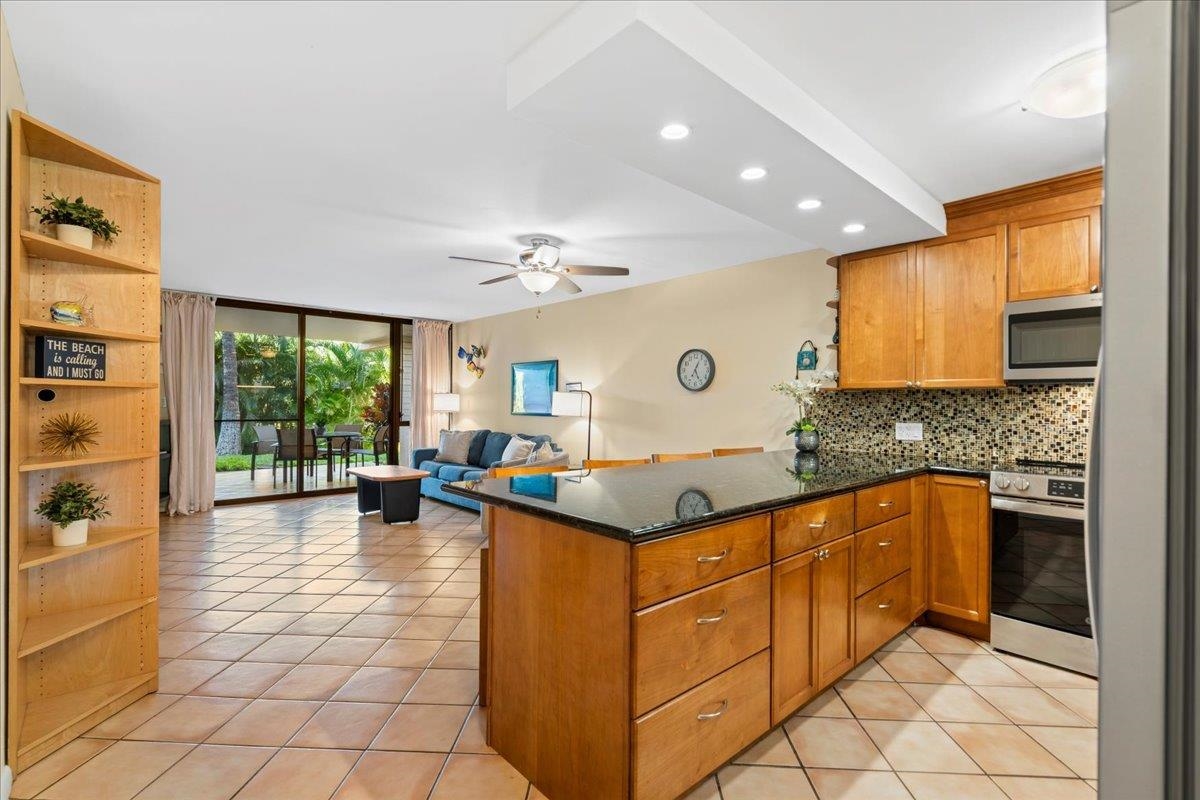 a kitchen with stainless steel appliances granite countertop a sink and cabinets