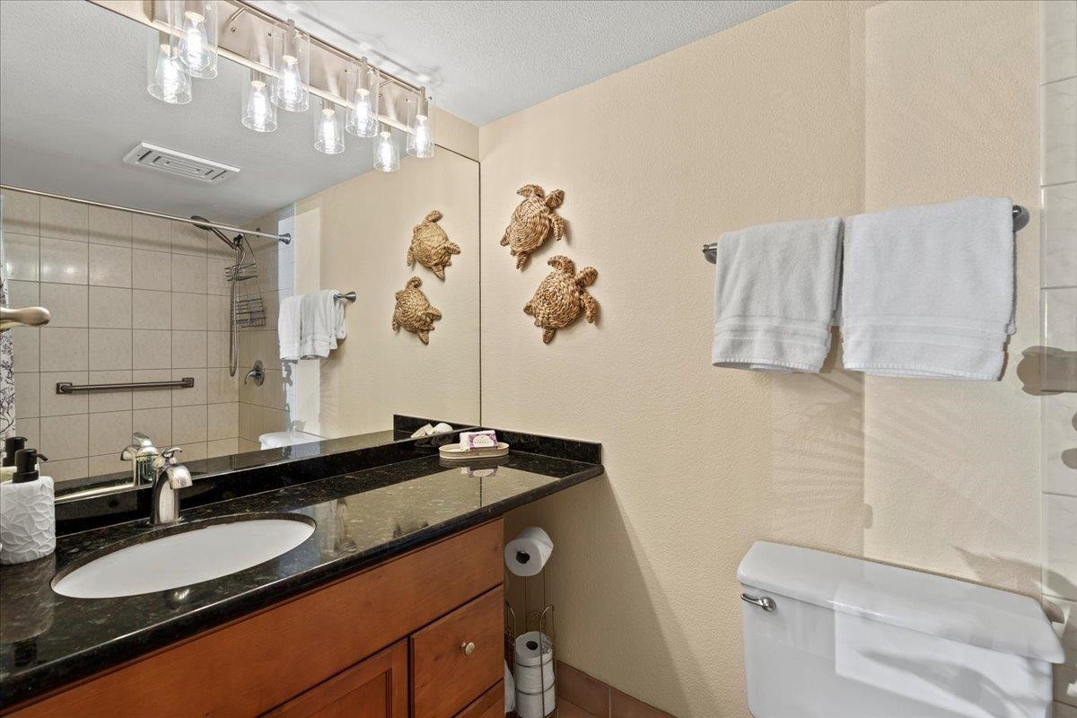 2695 South Kihei Road, Unit 6109 Kihei, HI 96753 - Photo 27 of 49 a bathroom with a granite countertop sink and a mirror