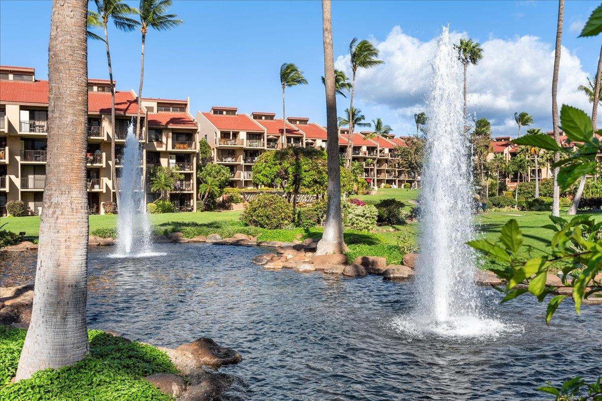 2695 South Kihei Road, Unit 6109 Kihei, HI 96753 - Photo 30 of 49 a front view of multi story residential apartment building with yard