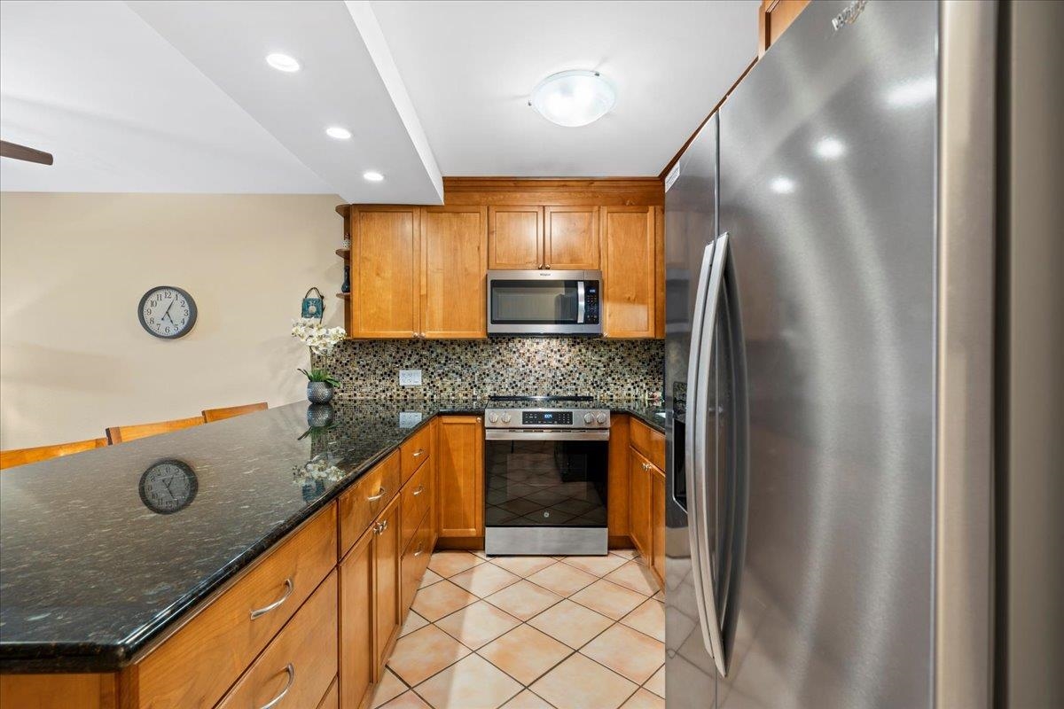 2695 South Kihei Road, Unit 6109 Kihei, HI 96753 - Photo 3 of 49 a kitchen with stainless steel appliances granite countertop a stove a sink and a refrigerator
