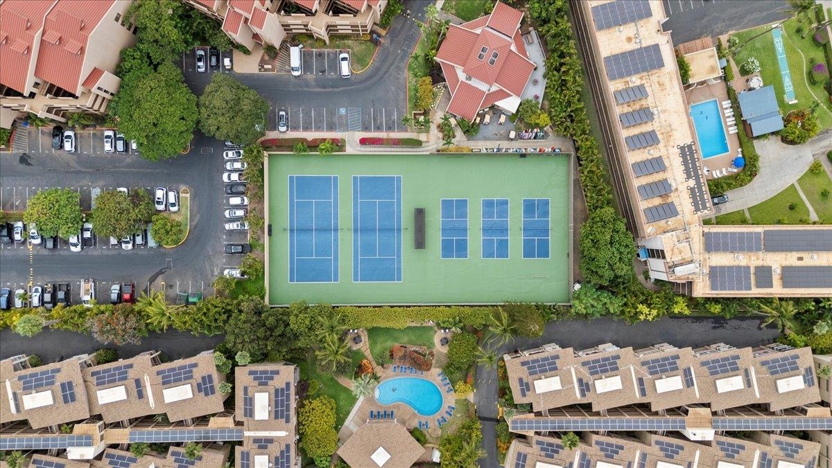 2695 South Kihei Road, Unit 6109 Kihei, HI 96753 - Photo 38 of 49 a front view of a residential apartment building with a yard