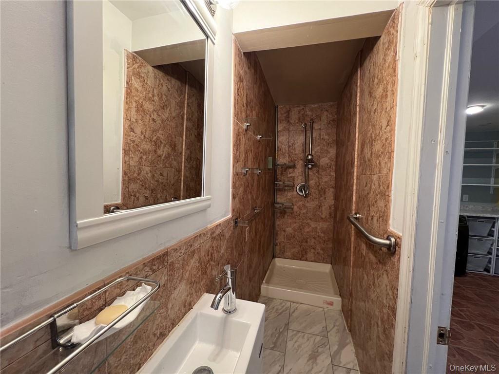 708 Silver Lake-Scotchtown Road Middletown, NY 10941 - Photo 9 of 25 Bathroom featuring tiled shower and tile walls