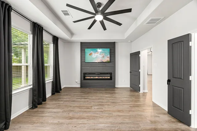 a view of an empty room with wooden floor
