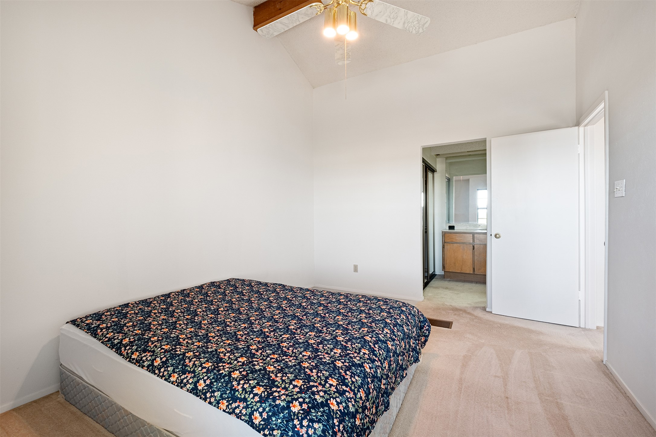 1748 Ohlen Road, Unit 16 Austin, TX 78757 - Photo 26 of 38 Bedroom with light carpet, lofted ceiling, a ceiling fan, and ensuite bathroom