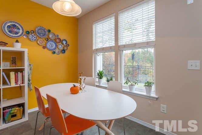 8402 Stoneyard Place Raleigh, NC 27613 - Photo 13 of 25 a dining room with furniture and a window