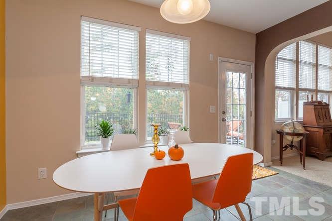 8402 Stoneyard Place Raleigh, NC 27613 - Photo 14 of 25 a view of a dining room with furniture and a large window