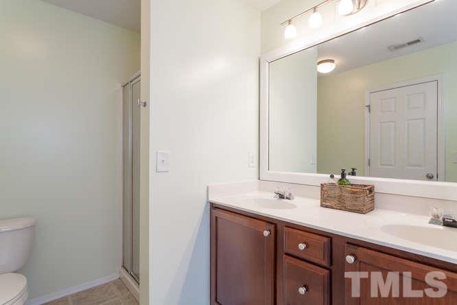 8402 Stoneyard Place Raleigh, NC 27613 - Photo 17 of 25 a bathroom with a sink and a mirror