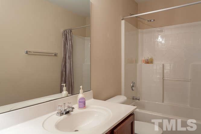 8402 Stoneyard Place Raleigh, NC 27613 - Photo 20 of 25 a bathroom with a sink and a mirror