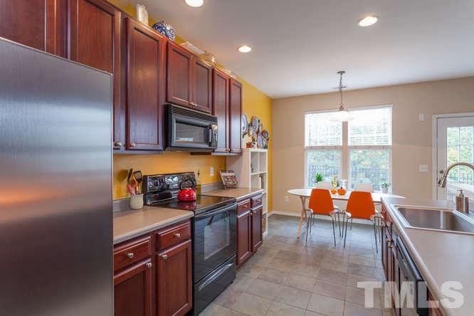 8402 Stoneyard Place Raleigh, NC 27613 - Photo 3 of 25 a kitchen with stainless steel appliances granite countertop a sink stove and cabinets