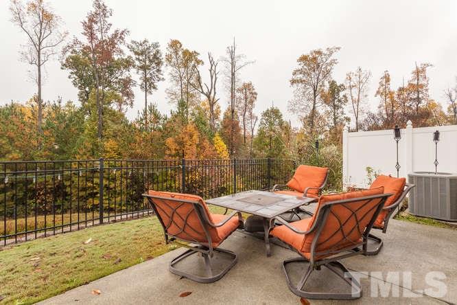 8402 Stoneyard Place Raleigh, NC 27613 - Photo 5 of 25 a backyard of a house with table and chairs