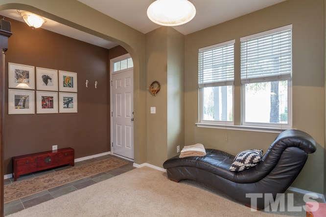 8402 Stoneyard Place Raleigh, NC 27613 - Photo 7 of 25 a living room with furniture and a window