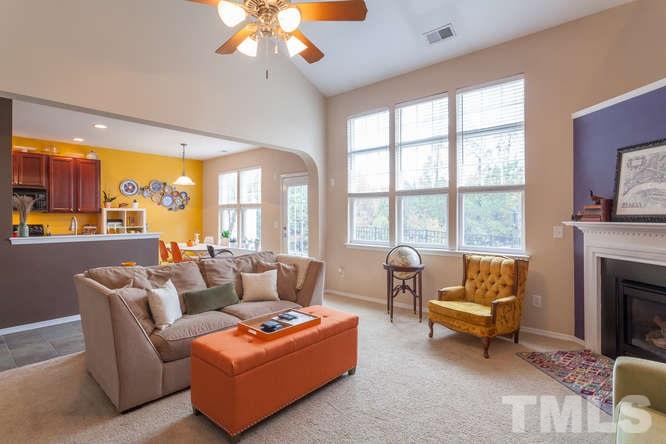 8402 Stoneyard Place Raleigh, NC 27613 - Photo 9 of 25 a living room with furniture and a fireplace