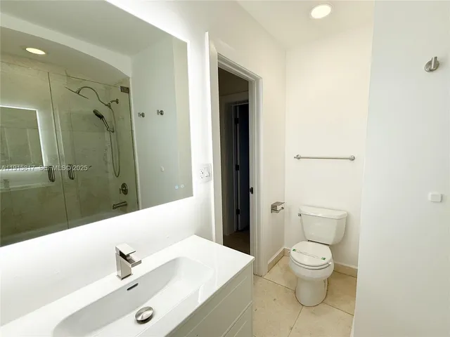 a view of a chandelier fan and wooden floor