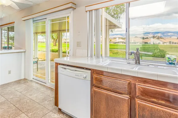 a kitchen with a sink and a large window