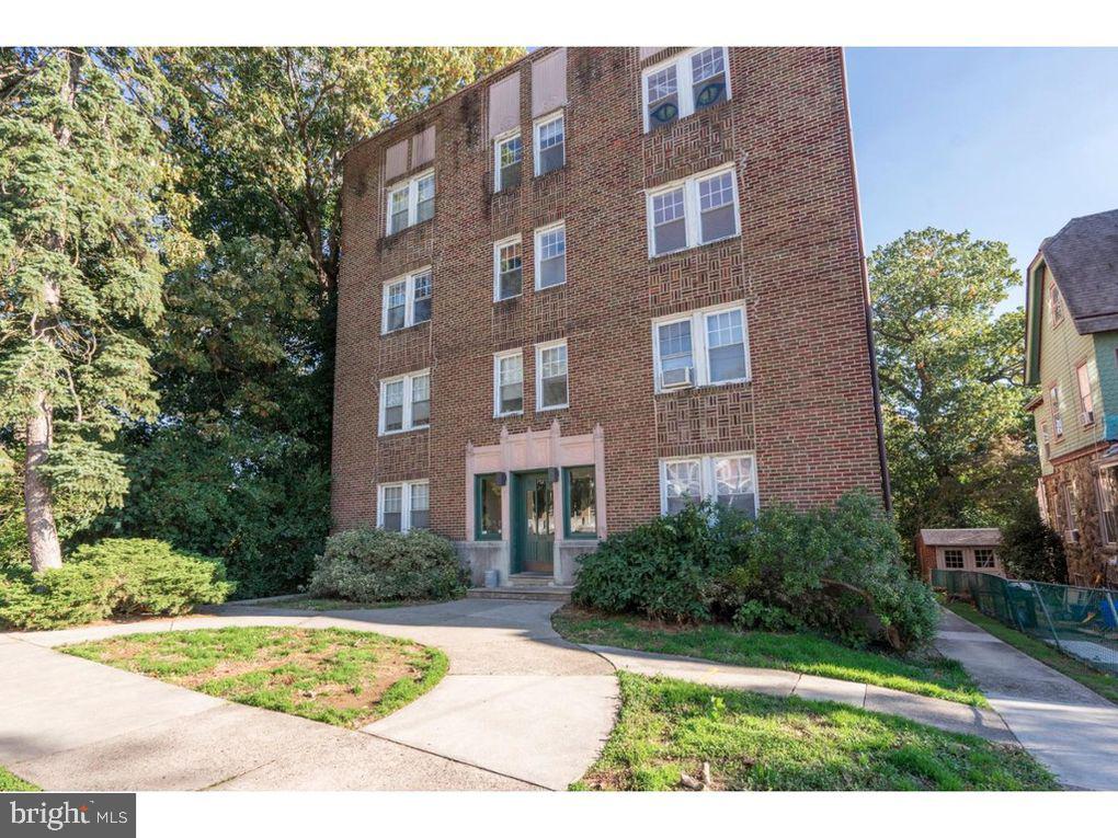 a view of a brick building next to a yard