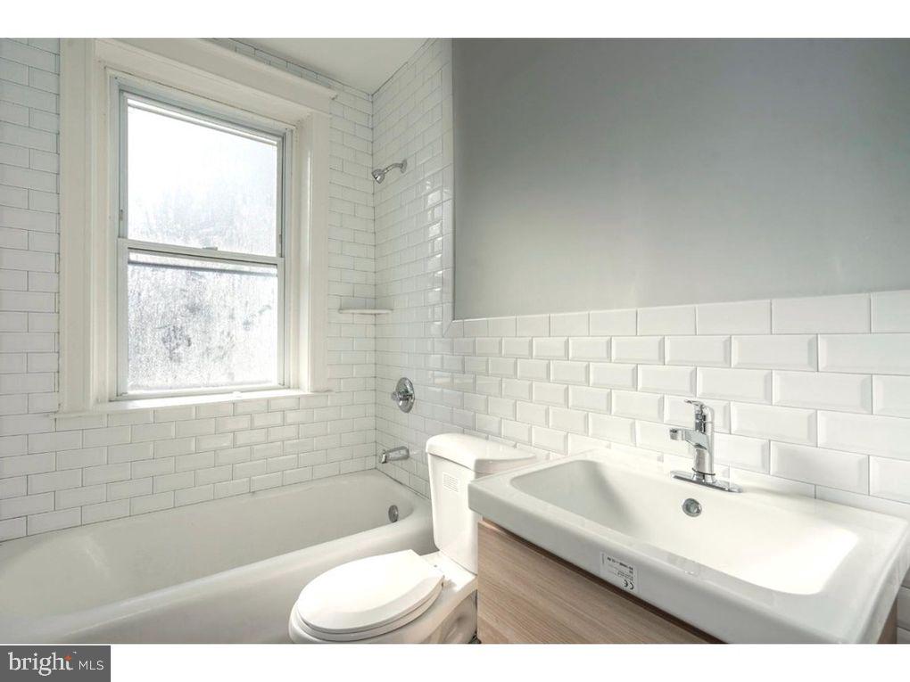 320 Rochelle Avenue, Unit 32 Philadelphia, PA 19128 - Photo 16 of 19 a bathroom with a sink a toilet and tub