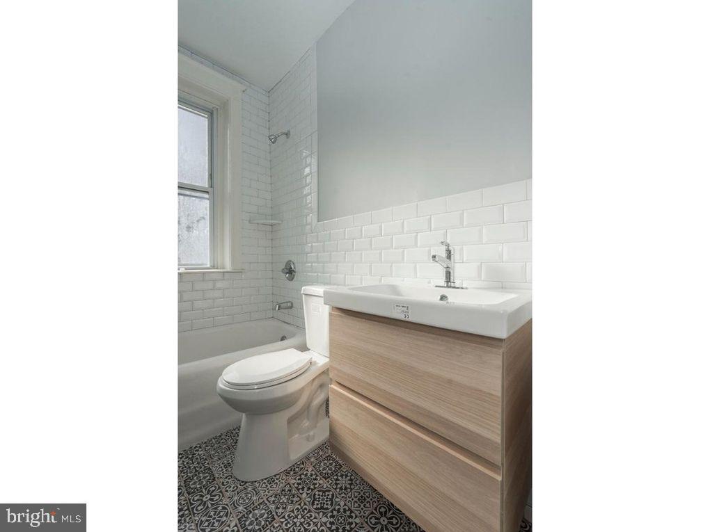 320 Rochelle Avenue, Unit 32 Philadelphia, PA 19128 - Photo 17 of 19 a bathroom with a sink toilet and a mirror
