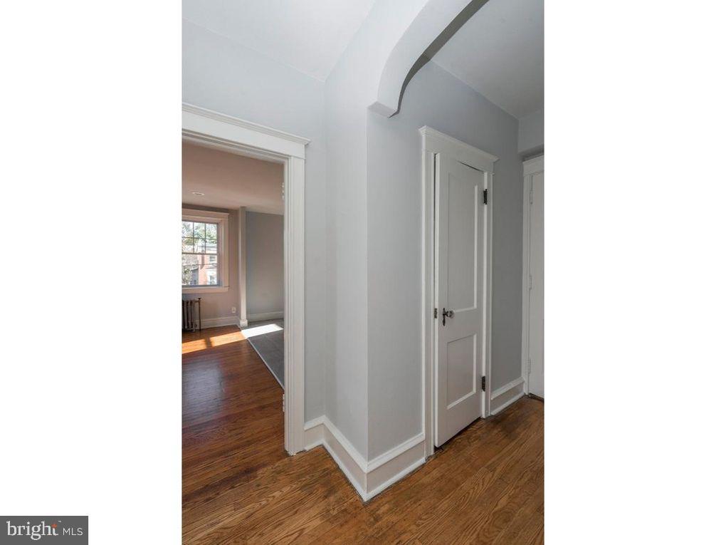 320 Rochelle Avenue, Unit 32 Philadelphia, PA 19128 - Photo 19 of 19 a view of a hallway with wooden floor and a bathroom
