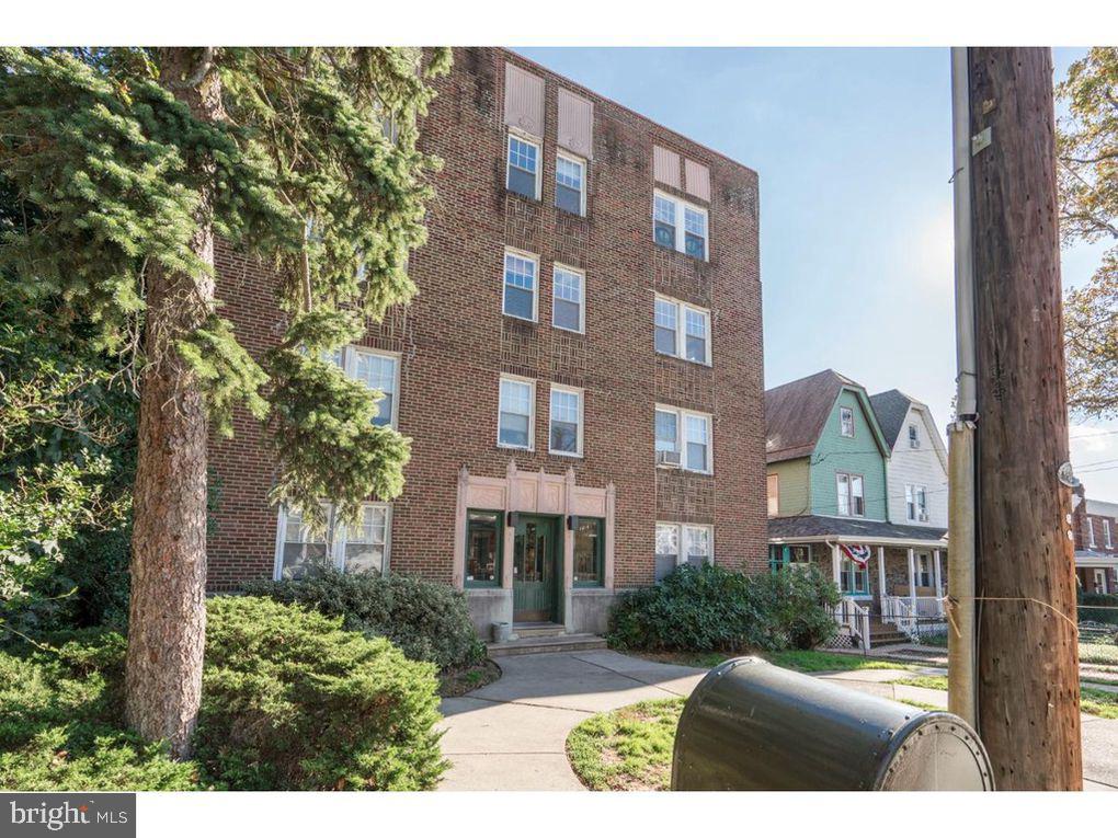 320 Rochelle Avenue, Unit 32 Philadelphia, PA 19128 - Photo 3 of 19 a view of a brick building next to a yard