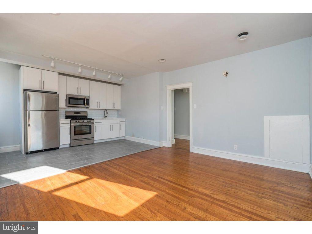 320 Rochelle Avenue, Unit 32 Philadelphia, PA 19128 - Photo 6 of 19 a kitchen with stainless steel appliances a refrigerator and a stove top oven