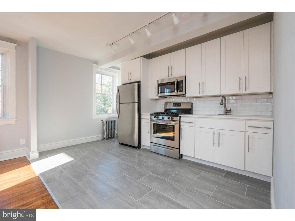 320 Rochelle Avenue, Unit 32 Philadelphia, PA 19128 - Photo 8 of 19 a kitchen with stainless steel appliances a refrigerator sink and microwave