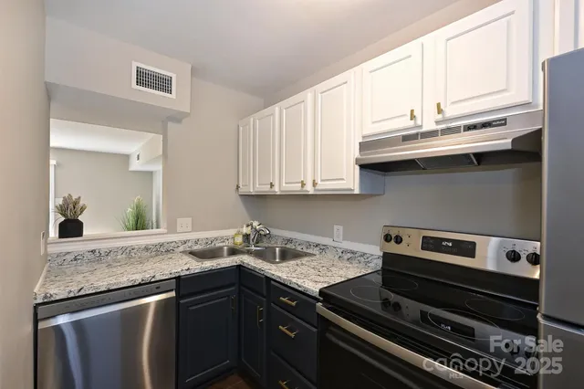 a kitchen with a sink stove and cabinets