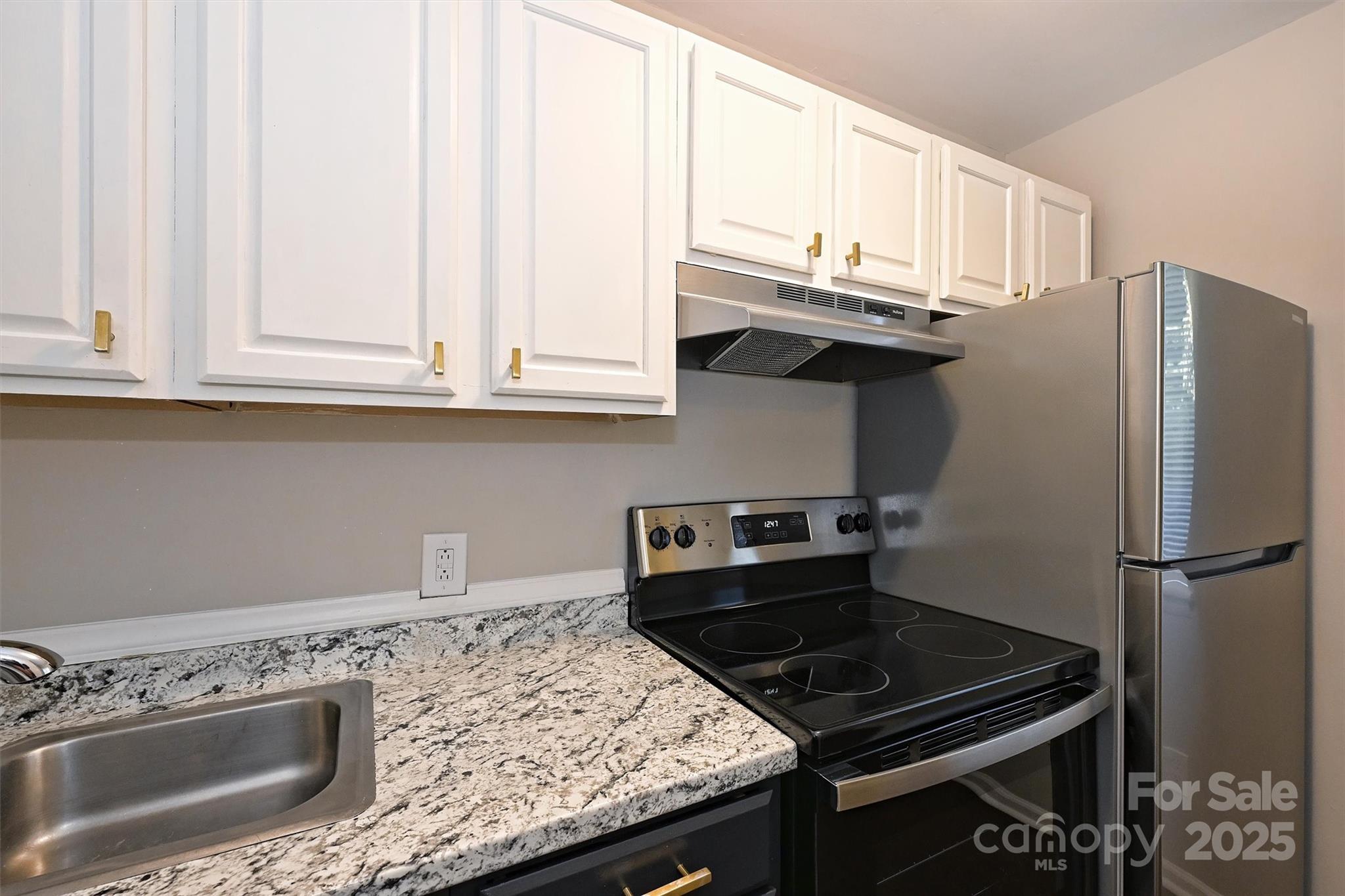 951 Hollywood Street, Unit F Charlotte, NC 28211 - Photo 13 of 42 a kitchen with granite countertop a stove sink and refrigerator
