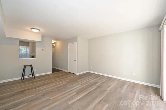 a view of an empty room and wooden floor