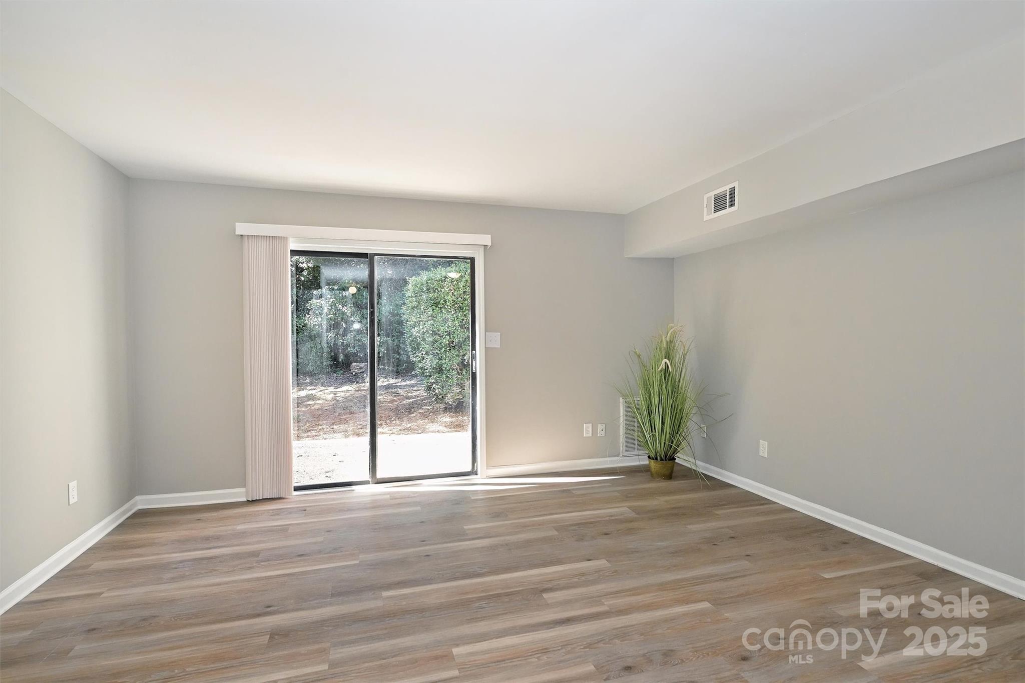 951 Hollywood Street, Unit F Charlotte, NC 28211 - Photo 20 of 42 wooden floor in an empty room with a window