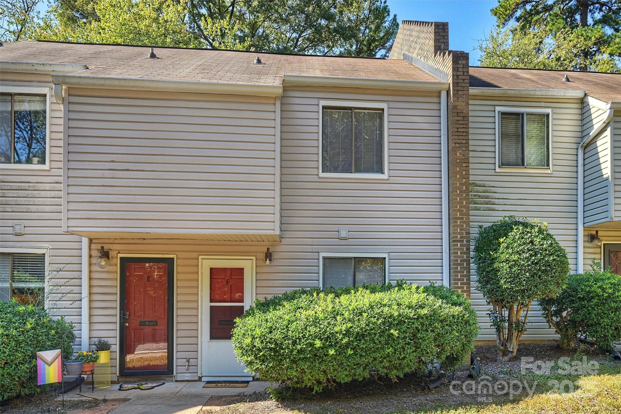 951 Hollywood Street, Unit F Charlotte, NC 28211 - Photo 2 of 42 a view of a house with potted plants and a large window