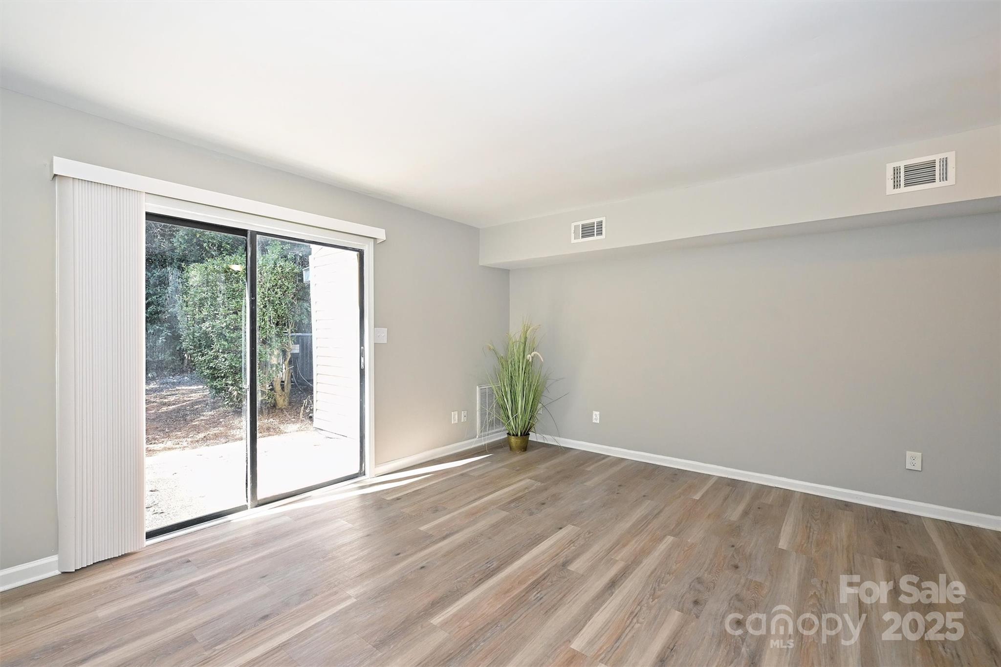 951 Hollywood Street, Unit F Charlotte, NC 28211 - Photo 21 of 42 a view of an empty room with wooden floor and a window