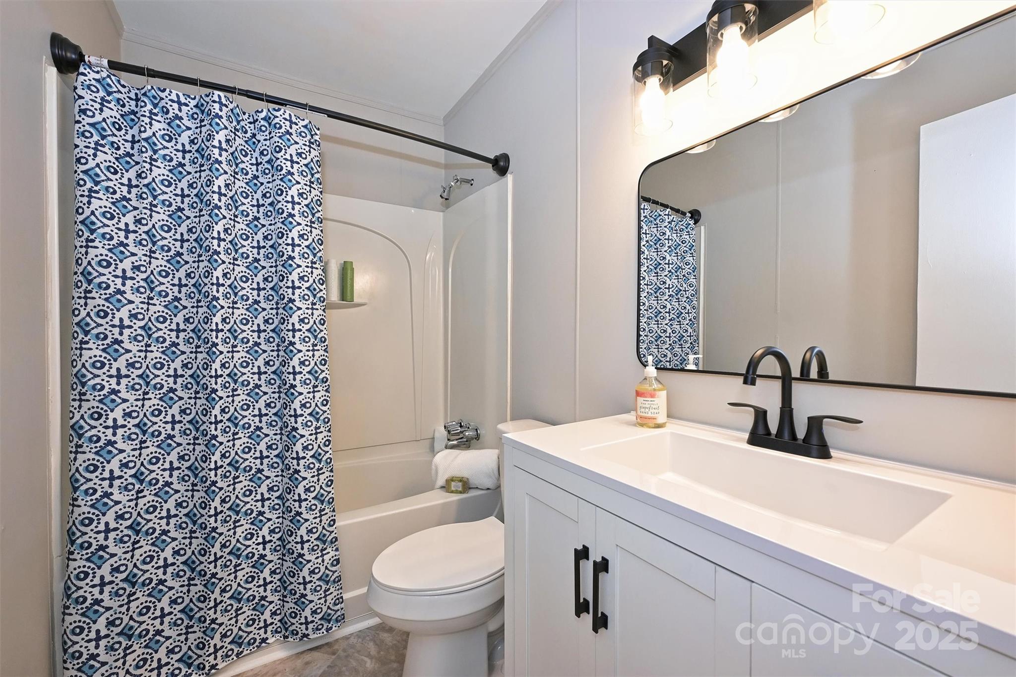 951 Hollywood Street, Unit F Charlotte, NC 28211 - Photo 28 of 42 a bathroom with a sink toilet and shower