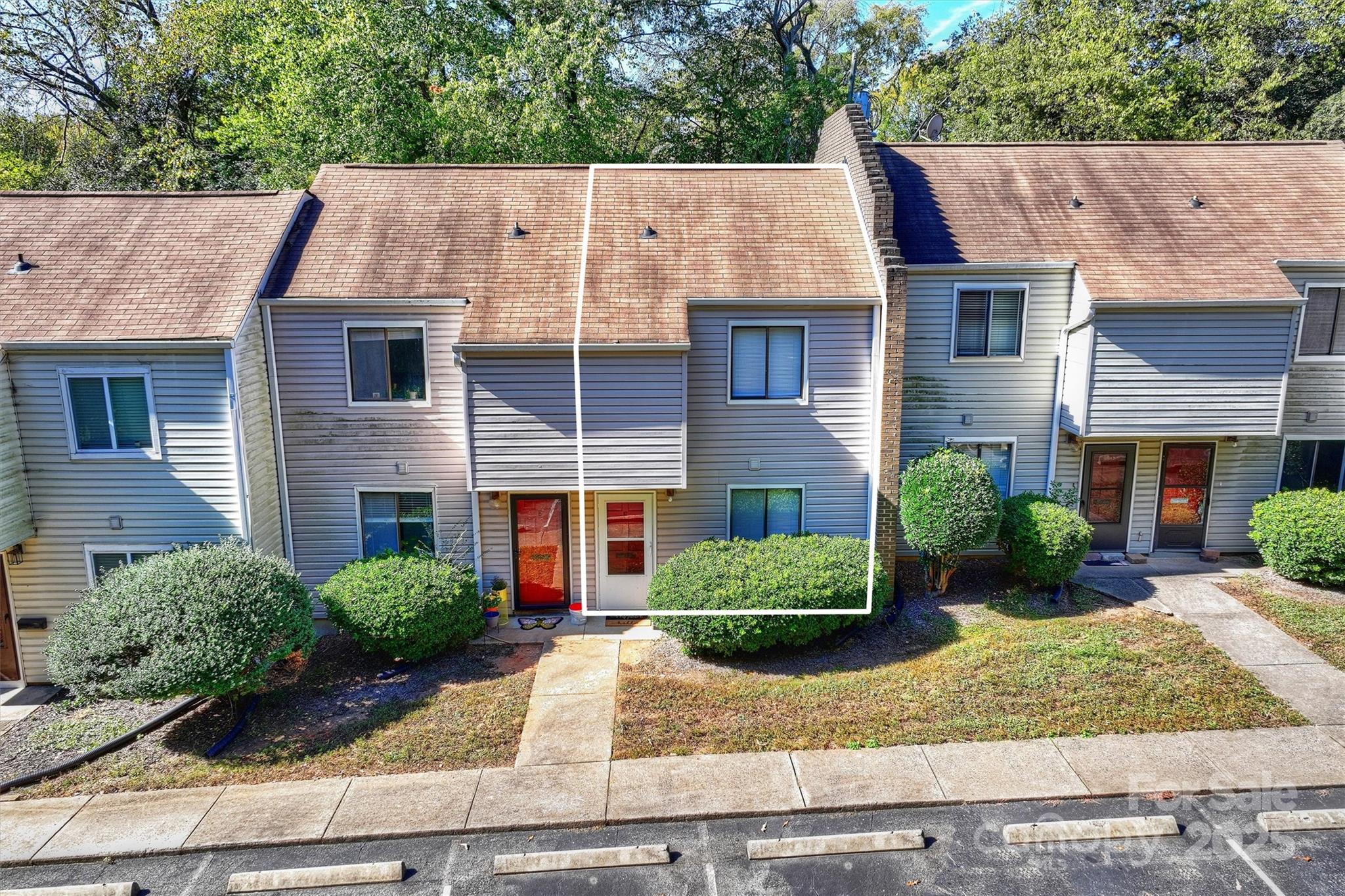 951 Hollywood Street, Unit F Charlotte, NC 28211 - Photo 4 of 42 a view of a white house with large windows plants and large tree