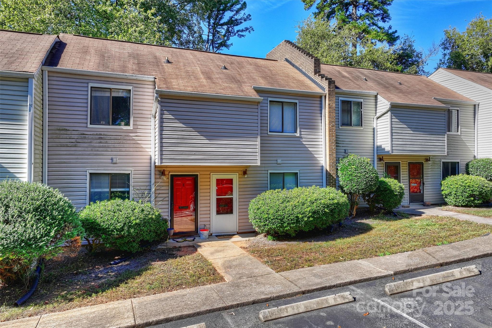 951 Hollywood Street, Unit F Charlotte, NC 28211 - Photo 5 of 42 a front view of a house with a yard and potted plants