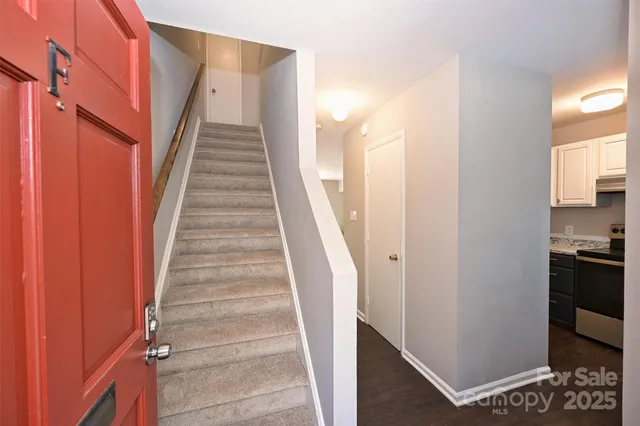 a view of staircase with white walls and a window