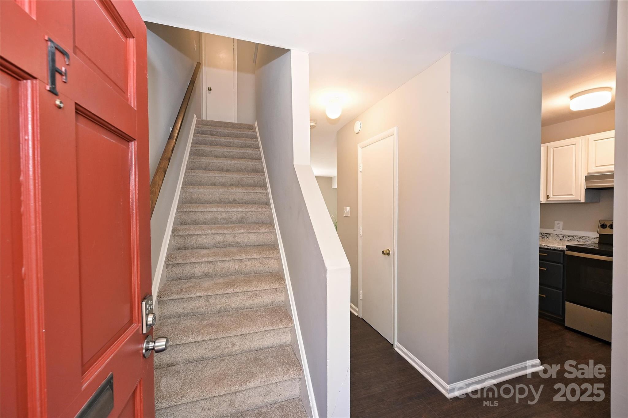 951 Hollywood Street, Unit F Charlotte, NC 28211 - Photo 8 of 42 a view of staircase with white walls and a window
