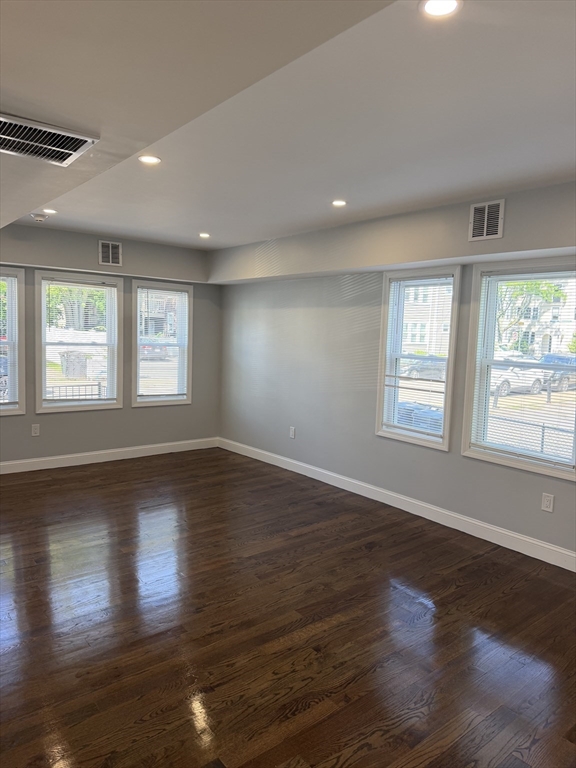 60-62 Wellsmere Road, Unit 2 Boston, MA 02131 - Photo 7 of 19 a view of an empty room with wooden floor and a window