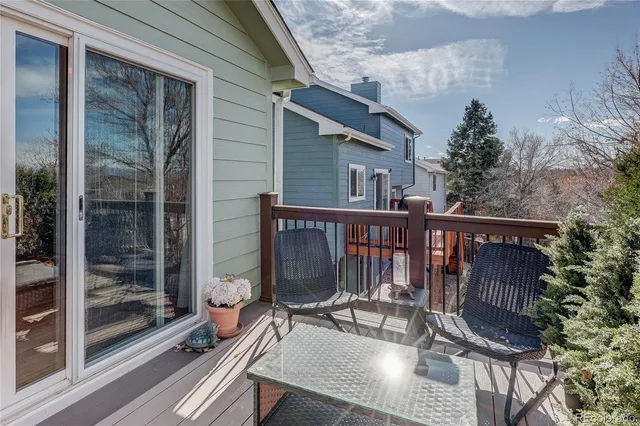 a view of balcony with wooden floor and outdoor seating