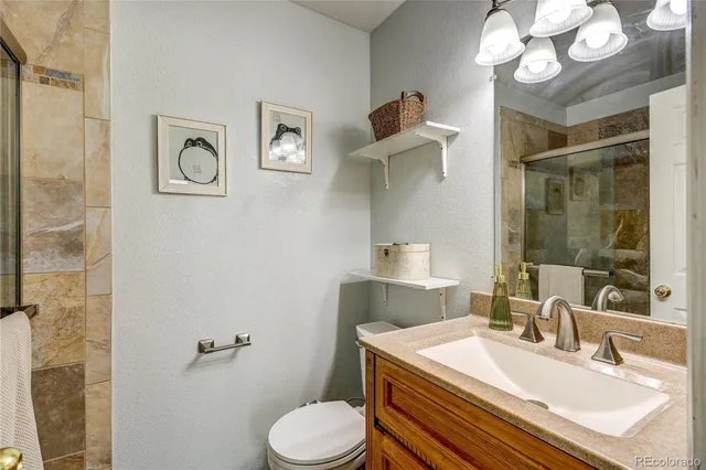 a bathroom with a sink a toilet and mirror