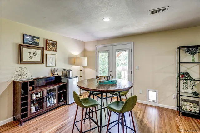 a view of a a dining room with furniture and wooden floor