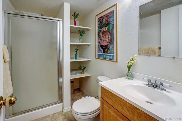 a bathroom with a sink a toilet and shower curtain