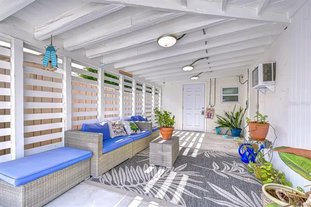 a living room with furniture and floor to ceiling window